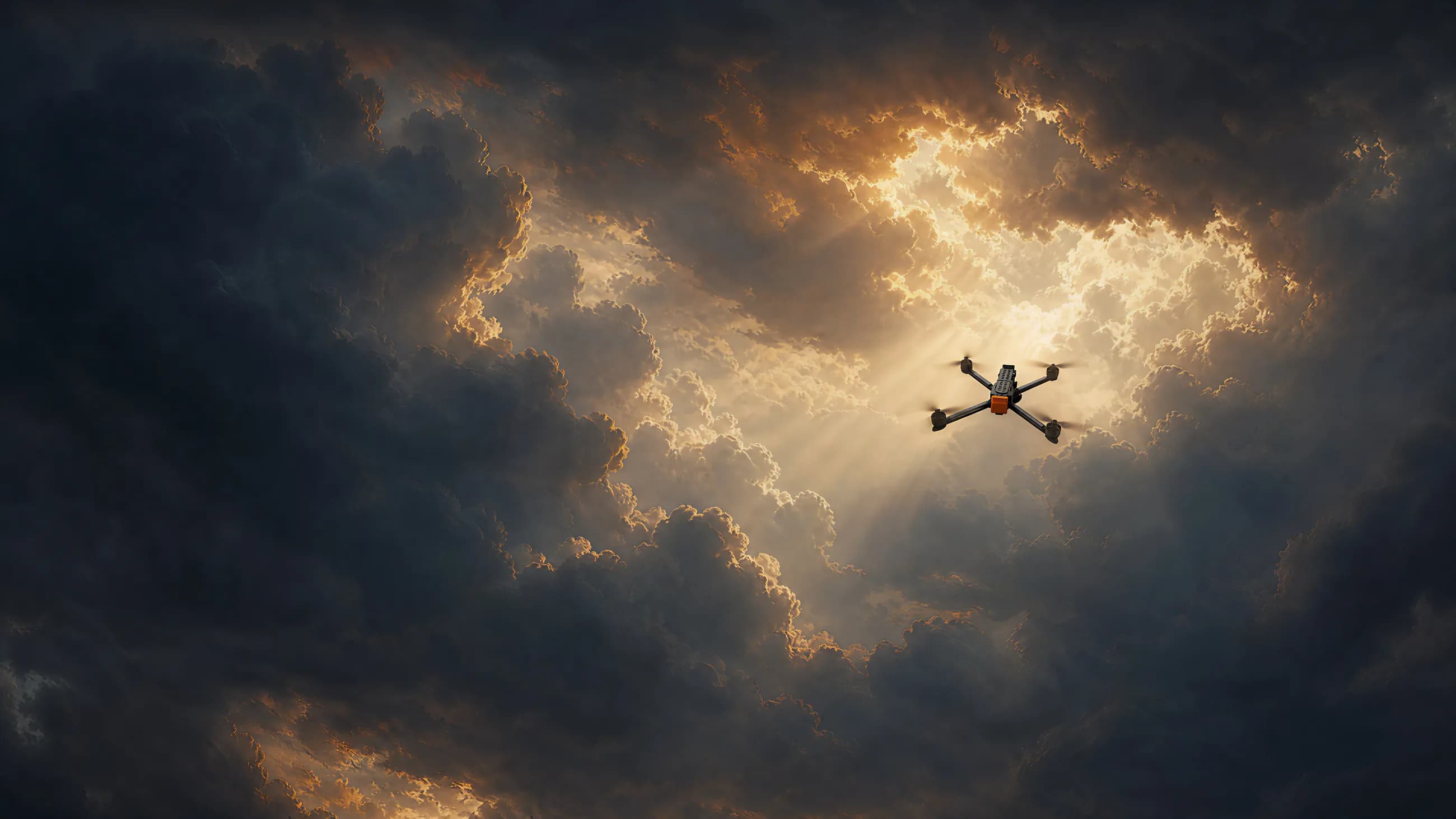 An Unmanned Industries T100 airframe in flight, backlit by sunlight breaking through storm clouds
